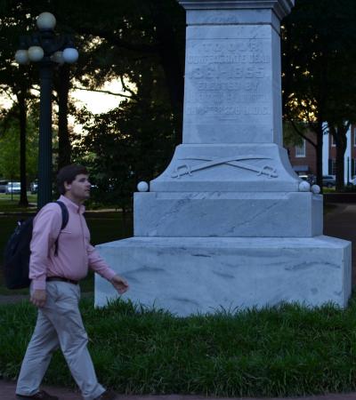 A students walks past a Confederate statute in the Circle. A students walks past a Confederate statute in the Circle.